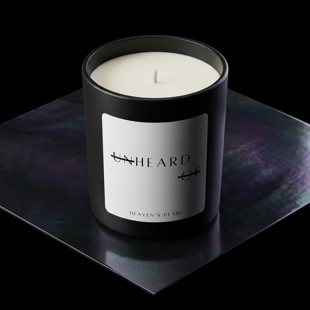 UNHEARD OF Heaven's Pearl candle, matte black jar with minimalist label, 8oz hand-poured coconut wax, orange blossom and fig scent profile.