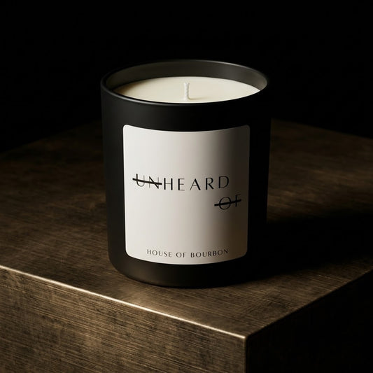 UNHEARD OF House of Bourbon luxury candle, matte black jar with minimalist label, 8oz hand-poured coconut wax, bourbon and tobacco scent with cedar base.